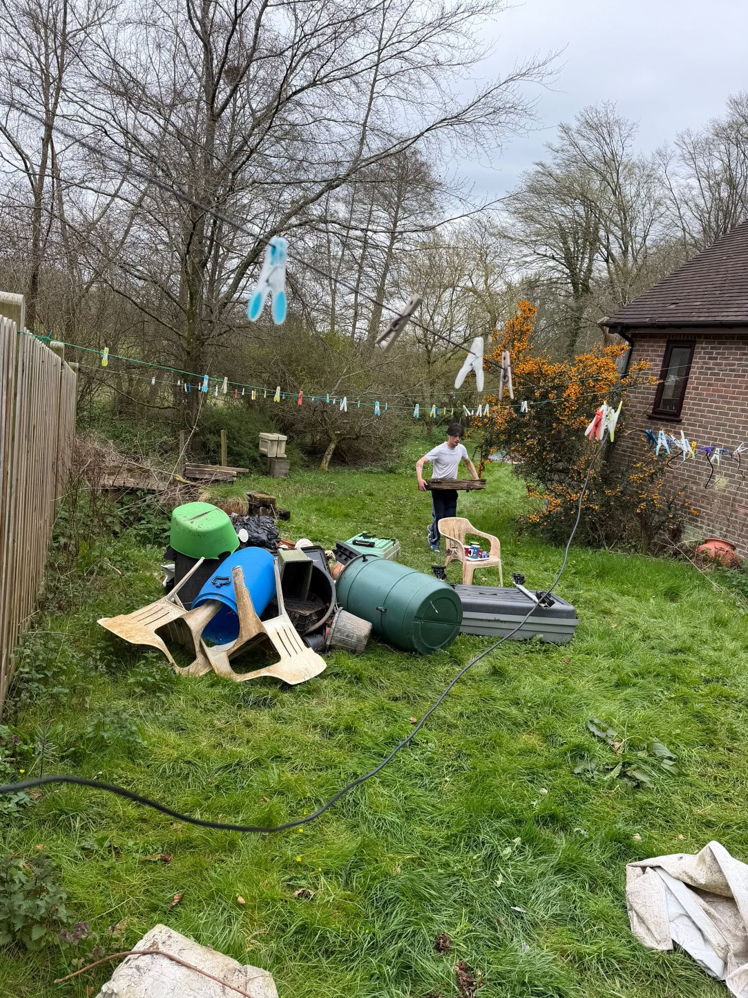 A member of the C1 Waste Removal team clearing garden waste by hand